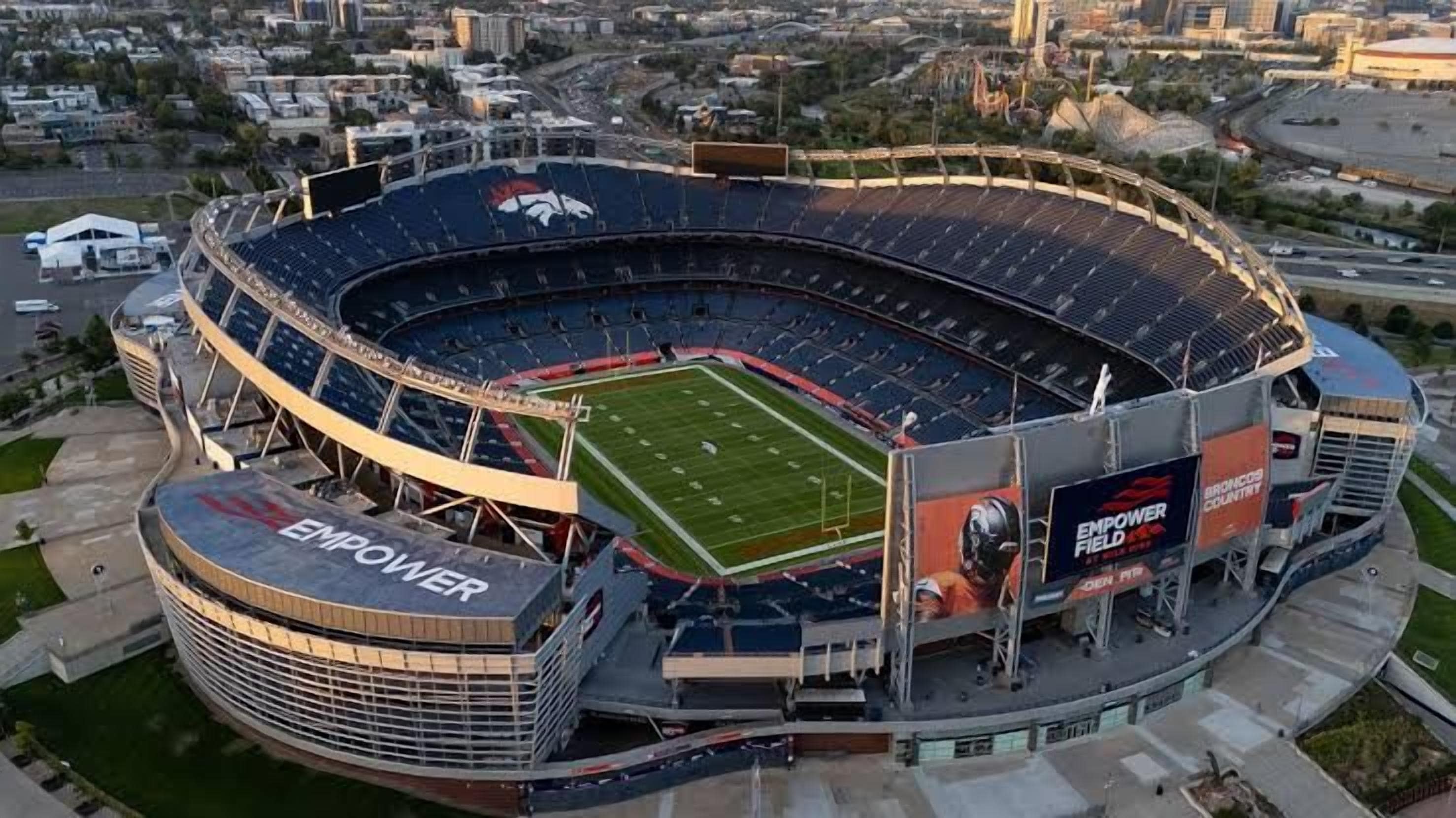 A large stadium with a curved roof and multiple tiers of seating.