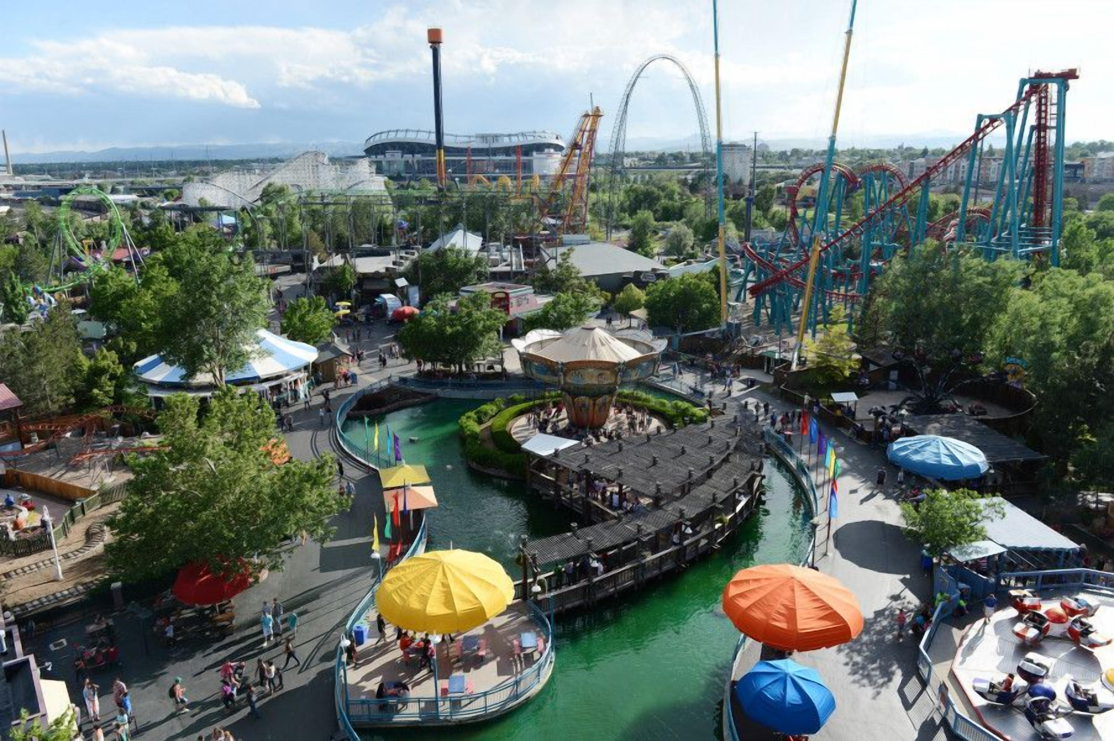 A theme park with a water ride, roller coaster, and various attractions.