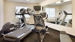 A gym with treadmills, a stationary bike, and a weight machine.