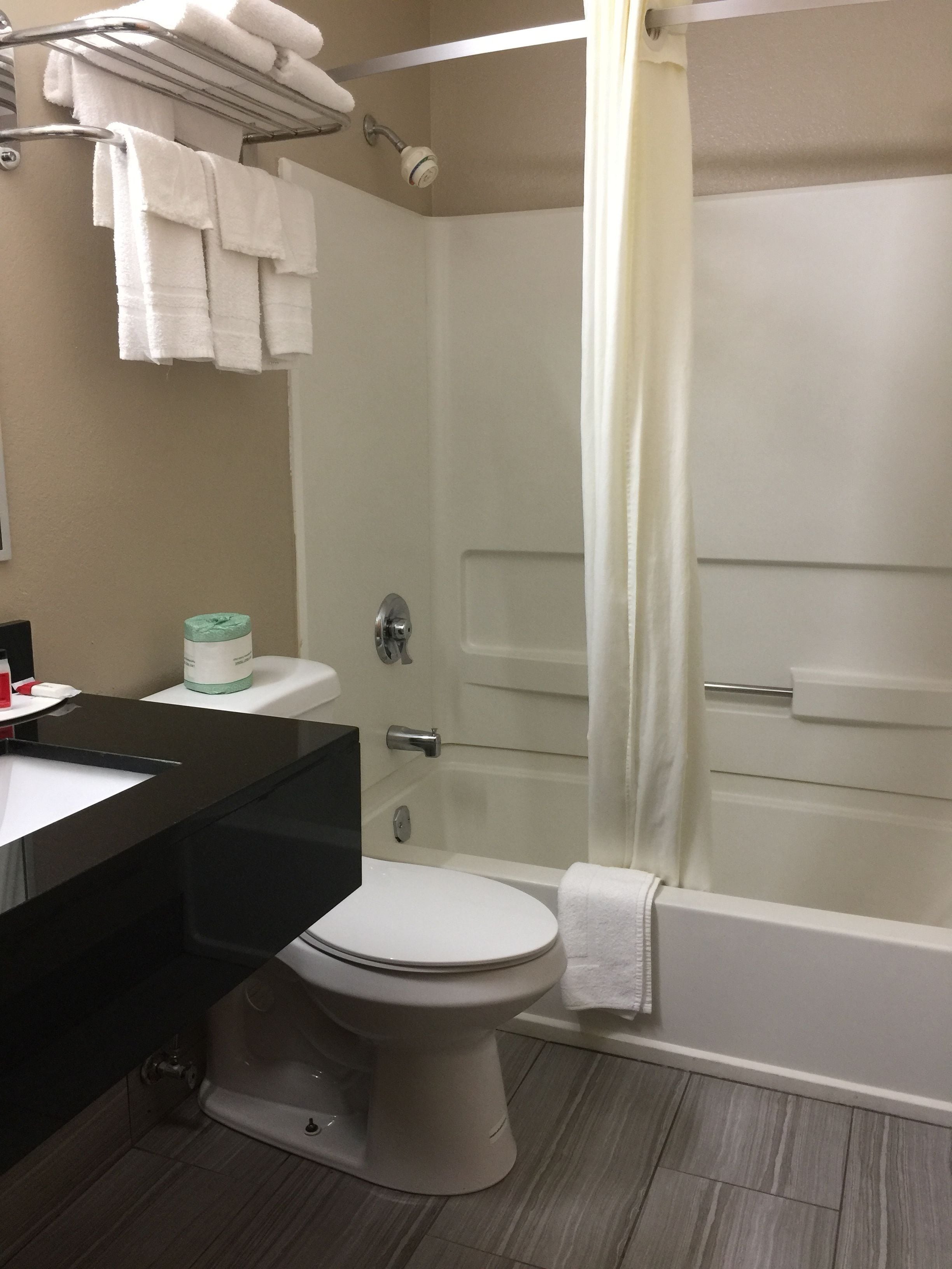 A bathroom with a toilet, sink, and bathtub.