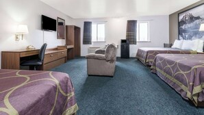 A hotel room with two beds, a desk, a chair, a TV, and a window.