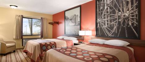 A hotel room with two beds, a large window, a chair, and a wall-mounted artwork.
