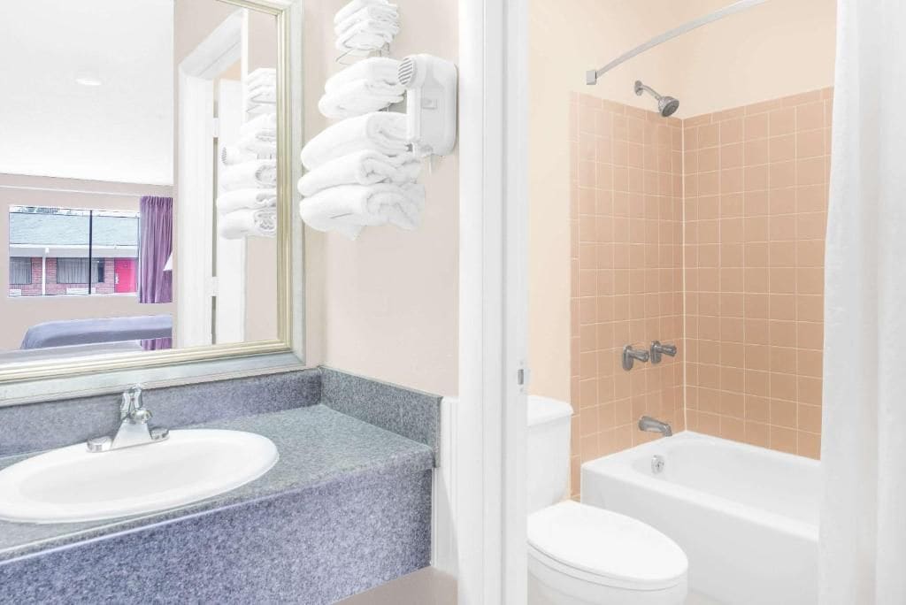 A bathroom with a sink, toilet, and bathtub.