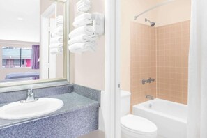 A bathroom with a sink, toilet, and bathtub.
