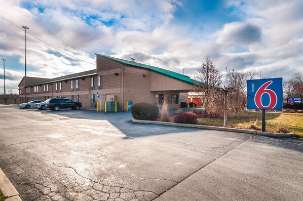 Simple motel with a flat roof and parking lot.