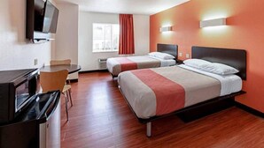 A hotel room with two beds, a desk, a chair, a TV, and a window with curtains. - Motel 6 Lebanon, IN (Lebanon)