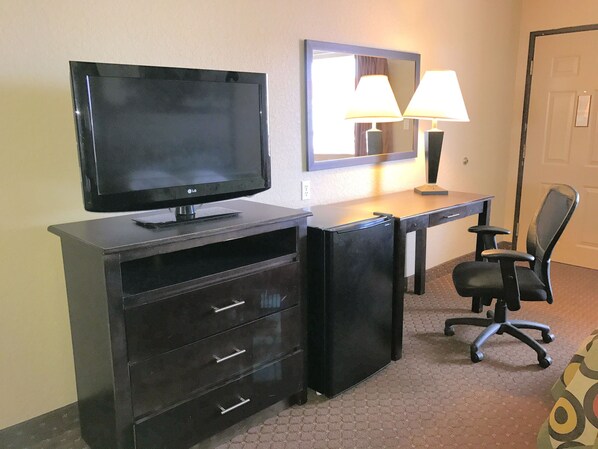 Relax in this cozy space with a flat-screen TV, desk, and comfortable chair.