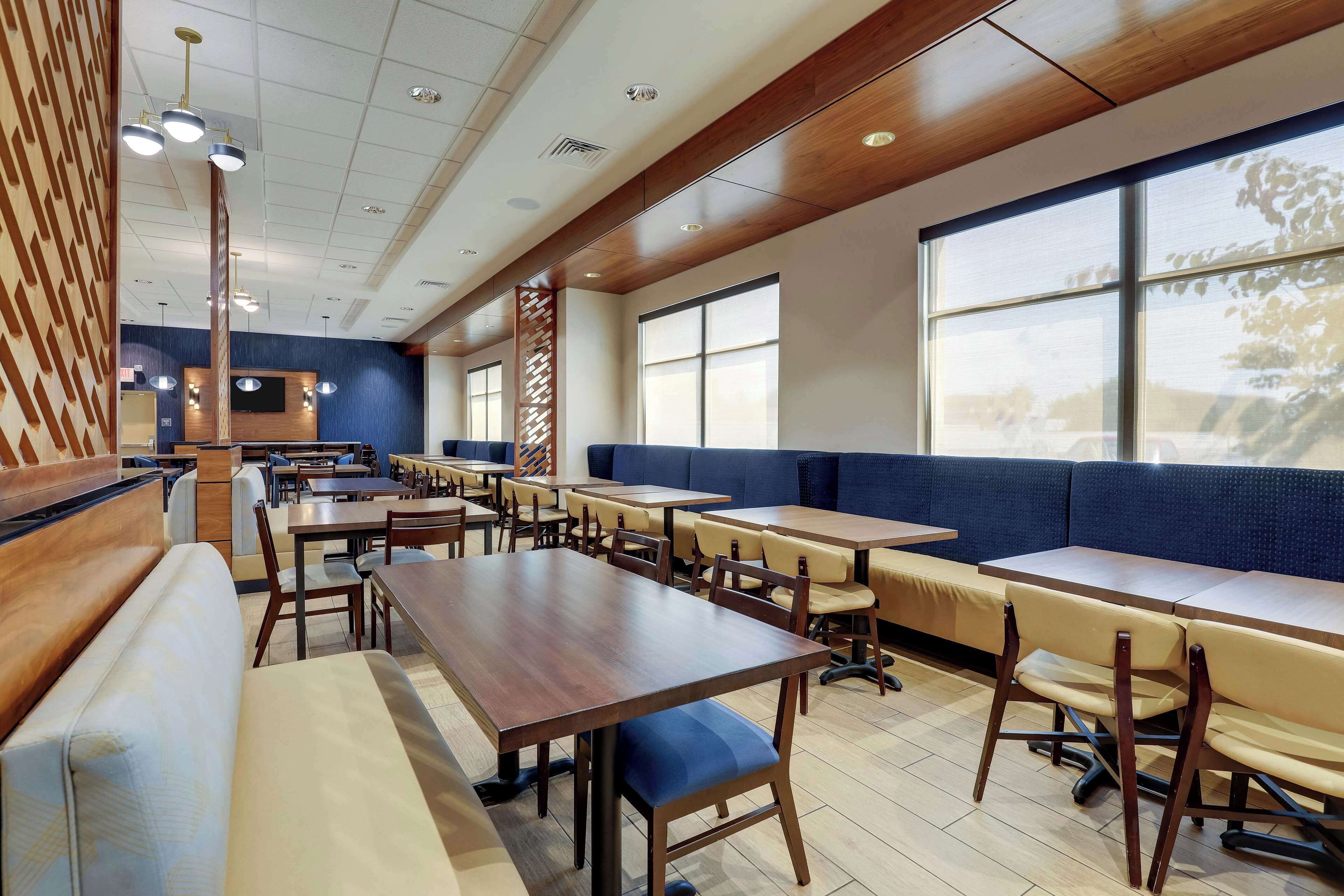 A restaurant with booths, tables, and a counter.