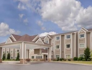 Stunning hotel entrance with a central walkway and beautifully landscaped surroundings.
