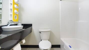 A bathroom with a white sink, toilet, and bathtub.
