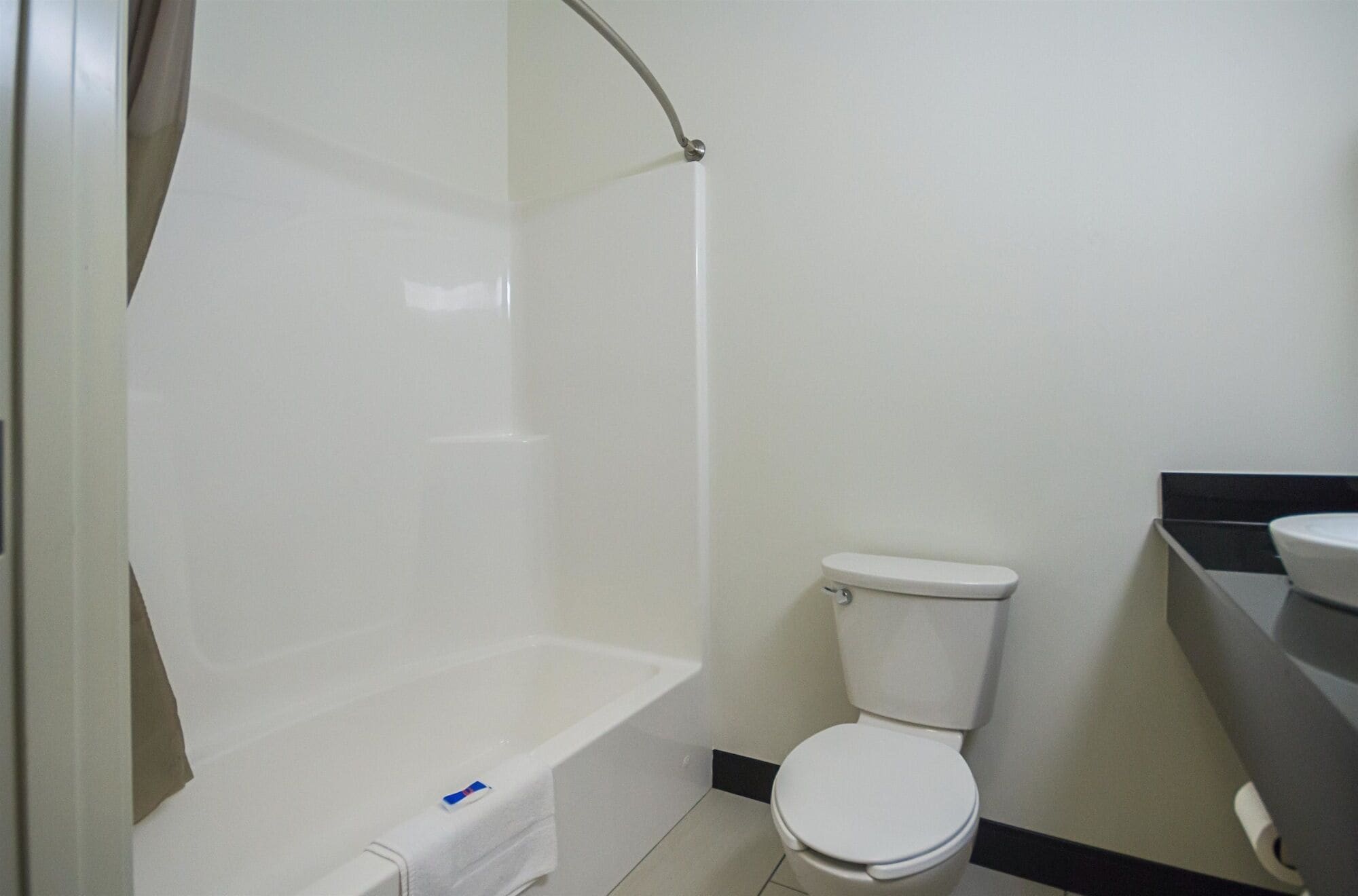 A bathroom with a bathtub, toilet, and sink.