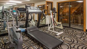 A gym with treadmills, ellipticals, and a stationary bike. - Baymont by Wyndham Metropolis (Metropolis)