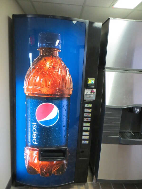 A vending machine with a Pepsi logo and a selection of snacks.