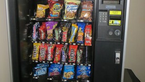A vending machine with various snacks and a 'Snack Attack!' sign.