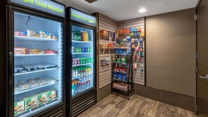 A Bright Side Market with refrigerated freezers stocked with snacks, drinks, and packaged goods.