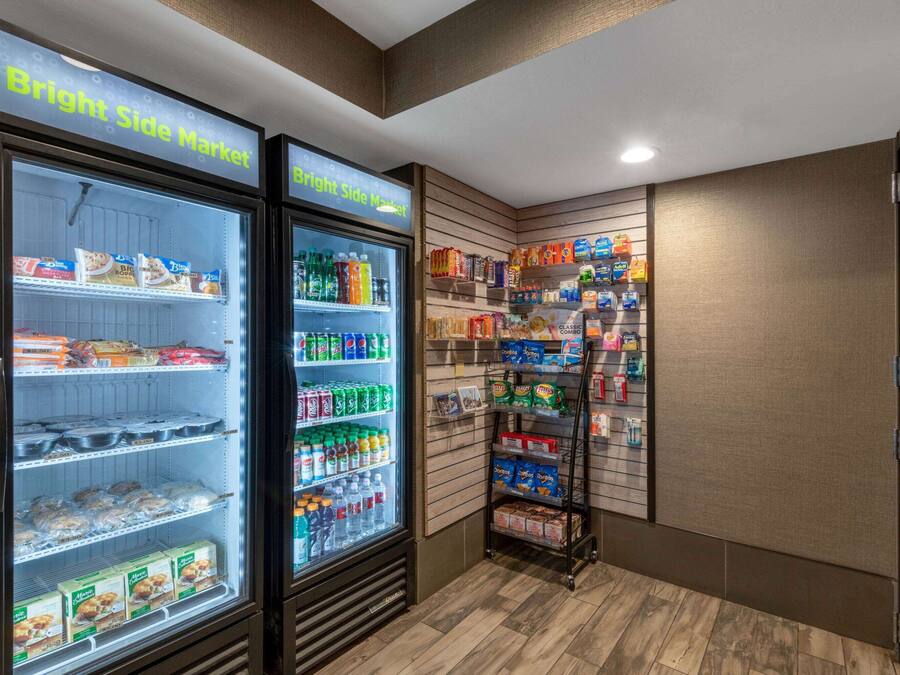 A Bright Side Market with refrigerated freezers stocked with snacks, drinks, and packaged goods.