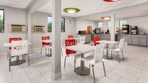 A modern dining area with white tables and chairs, a kitchen area with appliances, and a ceiling with recessed lighting.