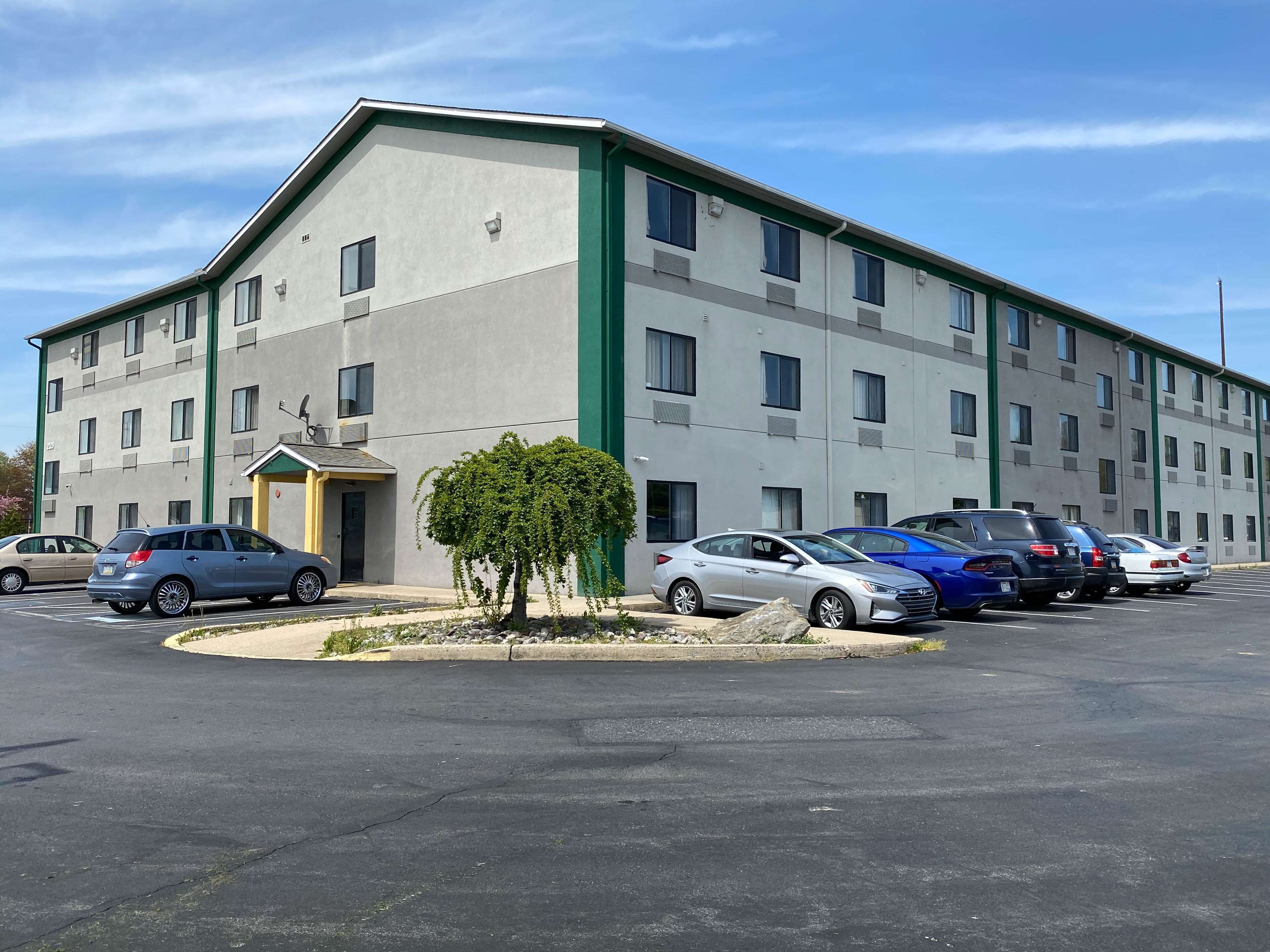 A multi-story hotel with a parking lot.