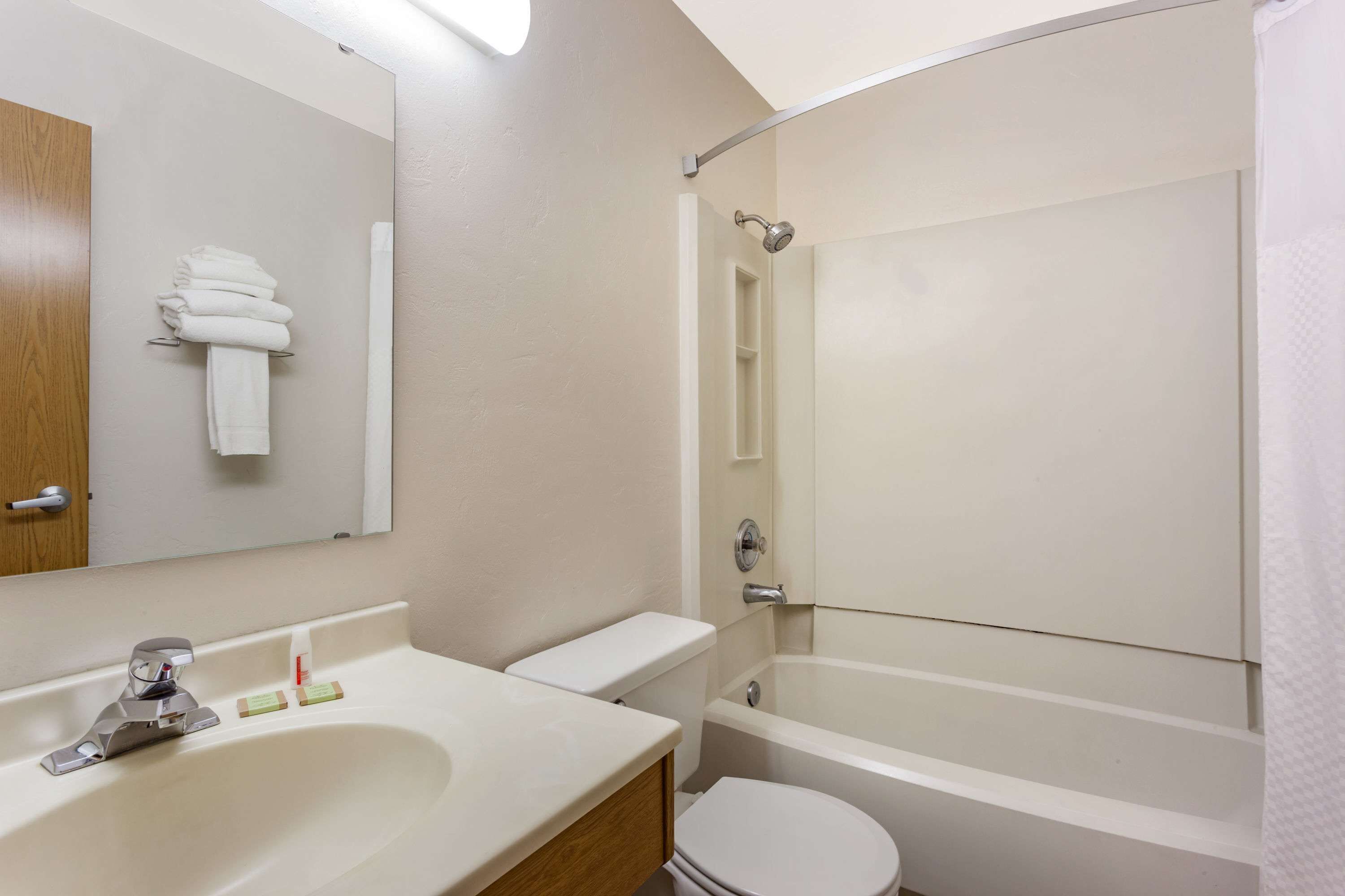 A bathroom with a sink, toilet, and bathtub.