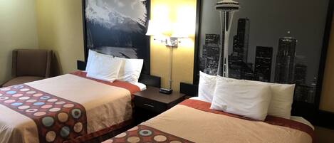 A hotel room with two beds, a cityscape mural on the wall, a lamp, and a chair.