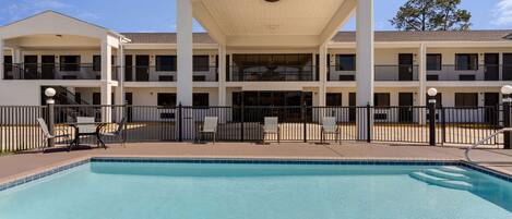 Un hotel con piscina, varios balcones y un letrero que dice "Super 8".