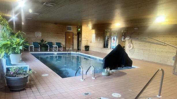 An indoor swimming pool with tiled flooring, a no diving sign, and a covered area. - Super 8 by Wyndham Sparta (Sparta)