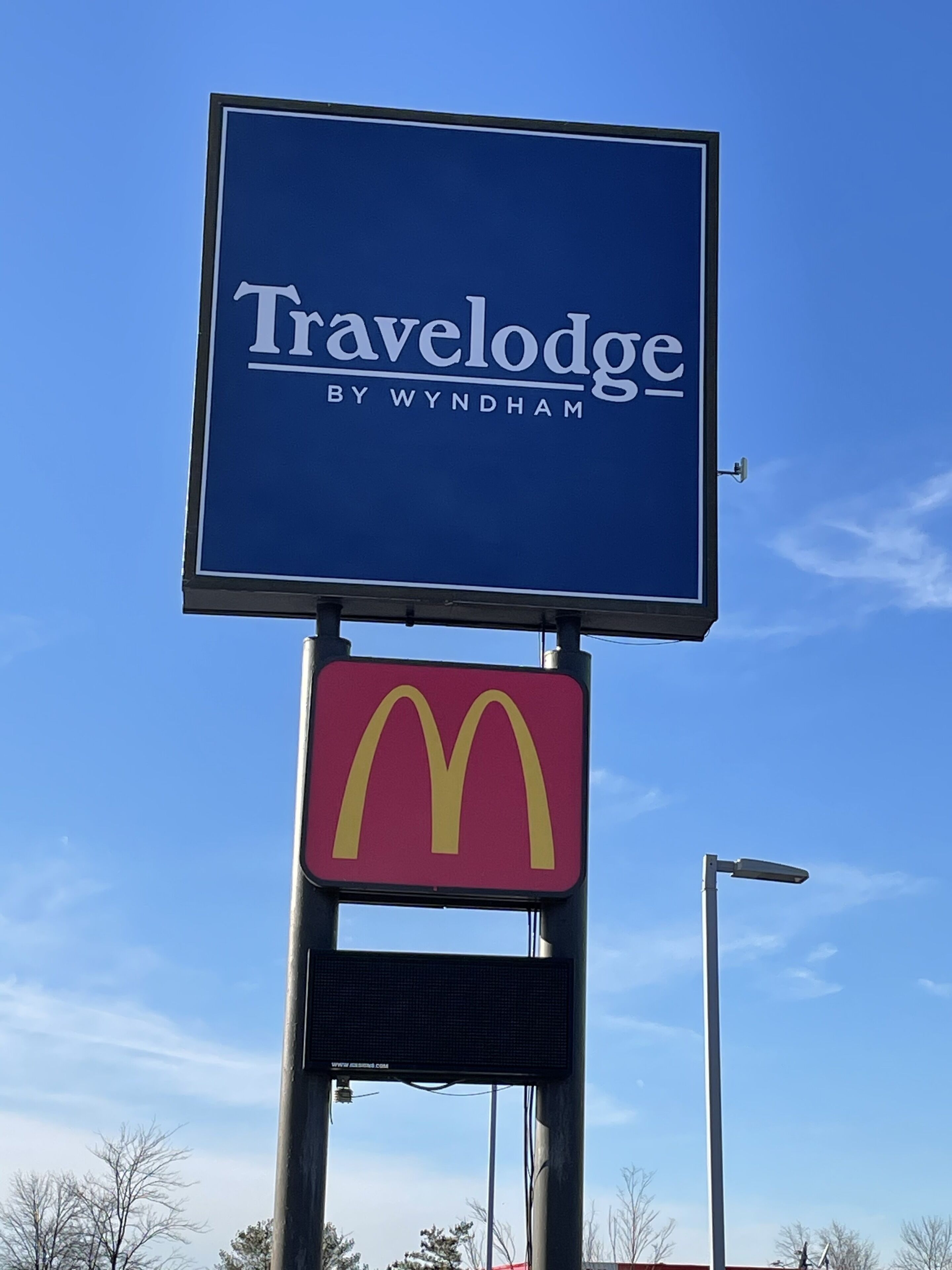 A Travelodge sign with a McDonald's logo below it.