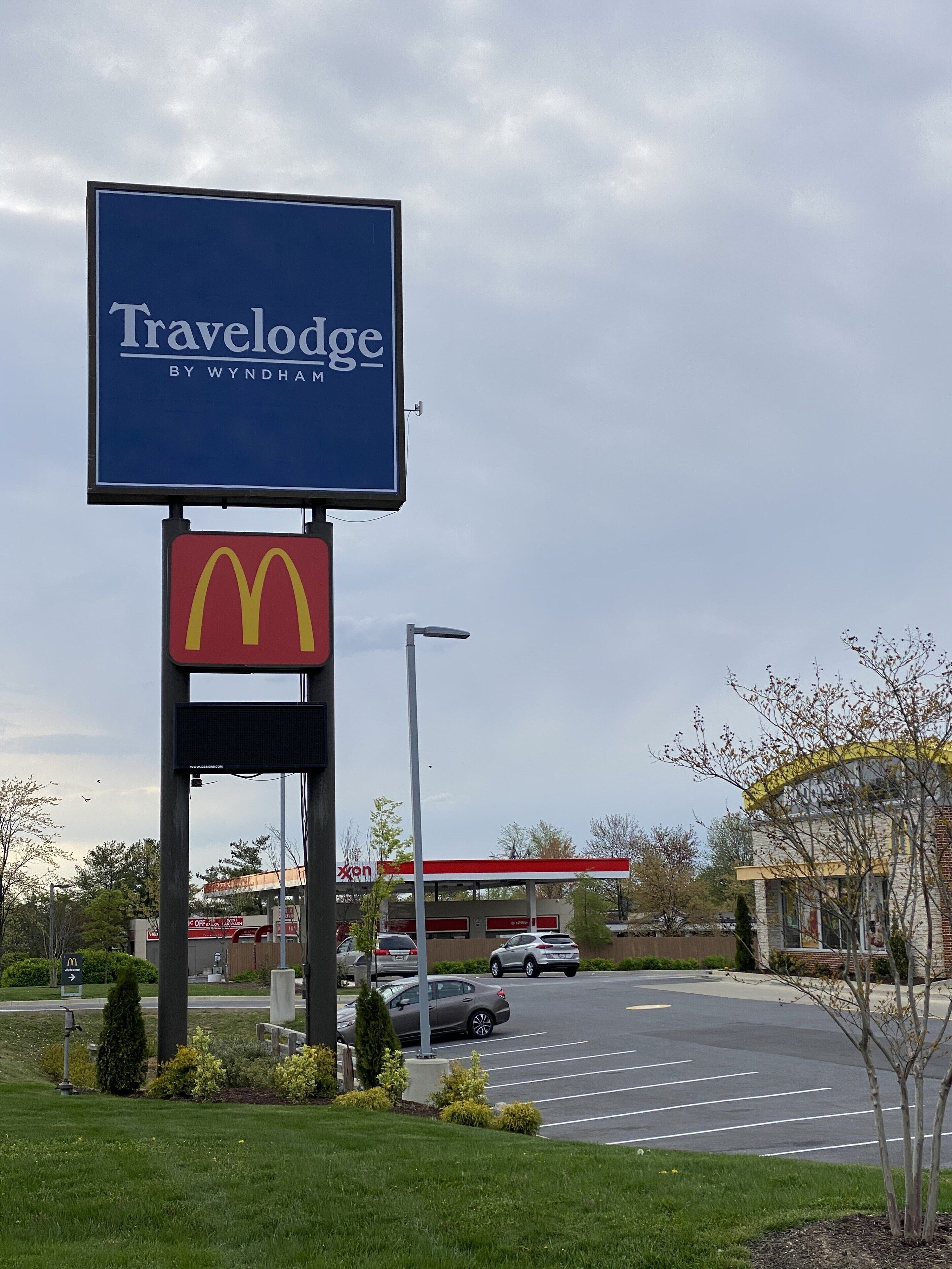A Travelodge sign with a McDonald's logo below it, indicating a Travelodge by Wyndham hotel with a McDonald's restaurant nearby.