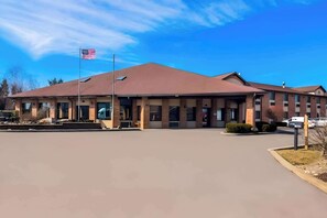 Hotel features a central entrance and two wings, with a flat roof and uniform windows.