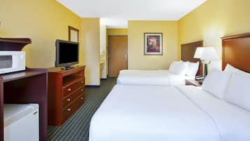A hotel room with a bed, a TV, a microwave, and a small refrigerator.