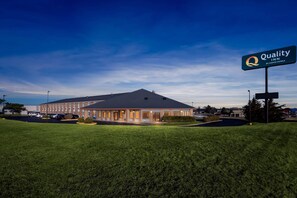 A hotel with a large sign reading 'Quality Inn by Choice Hotels.'