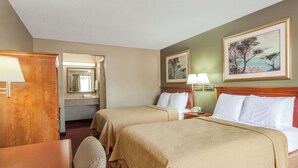 A hotel room with two beds, a desk, a chair, a mirror, and two paintings on the wall. - Knights Inn Lebanon (Lebanon)