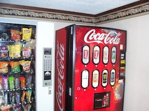A vending machine with snacks and a Coca-Cola machine. - Americas Best Value Inn & Suites Warren Detroit (Warren)