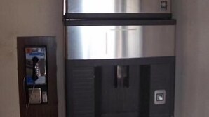 A stainless steel refrigerator with a freezer compartment on top and a lower section with a control panel. - Americas Best Value Inn & Suites Warren Detroit (Warren)