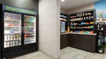 A grocery store with refrigerated sections and shelves stocked with various products.