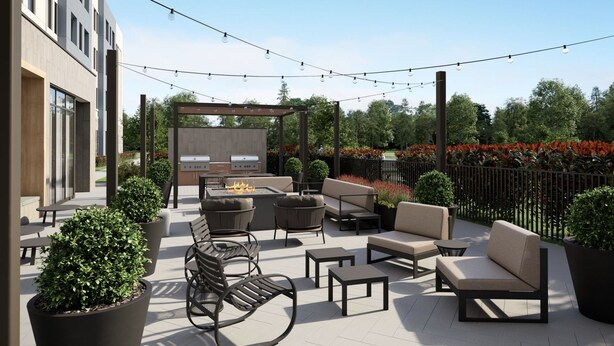 An outdoor patio area with seating, a barbecue grill, and string lights. - Staybridge Suites Detroit Woodhaven by IHG (Woodhaven)