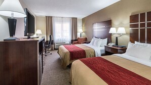 A hotel room with two beds, a desk, a TV, and a window with curtains. - Quality Inn Parkersburg North - Vienna (Parkersburg)