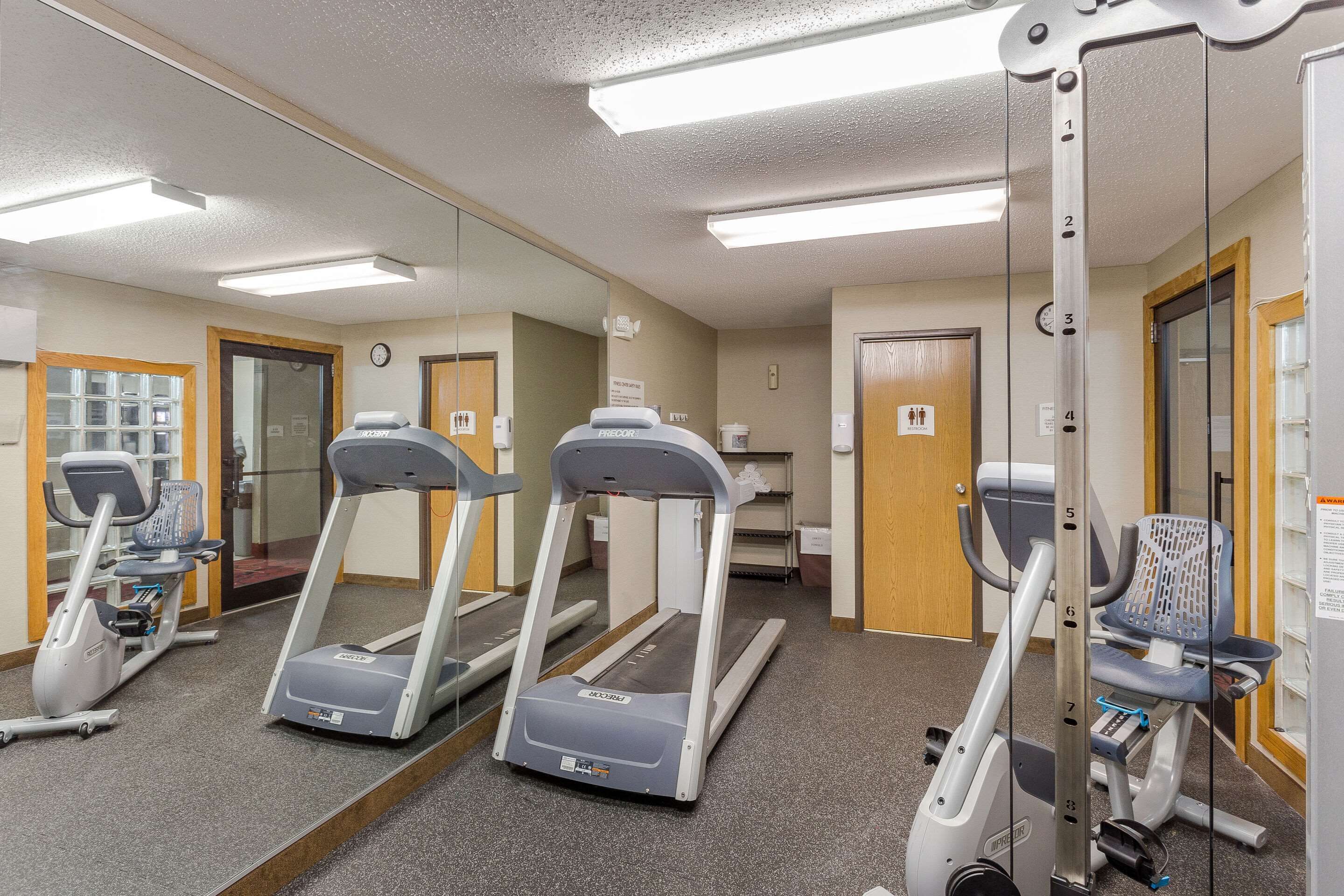 A gym with treadmills, an elliptical, and a weight machine.