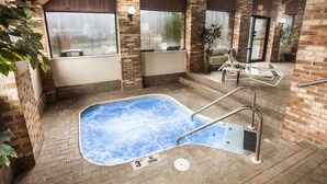 An indoor swimming pool with a 3ft no diving sign, surrounded by brick walls and wooden beams. - Quality Inn Athens (Athens)