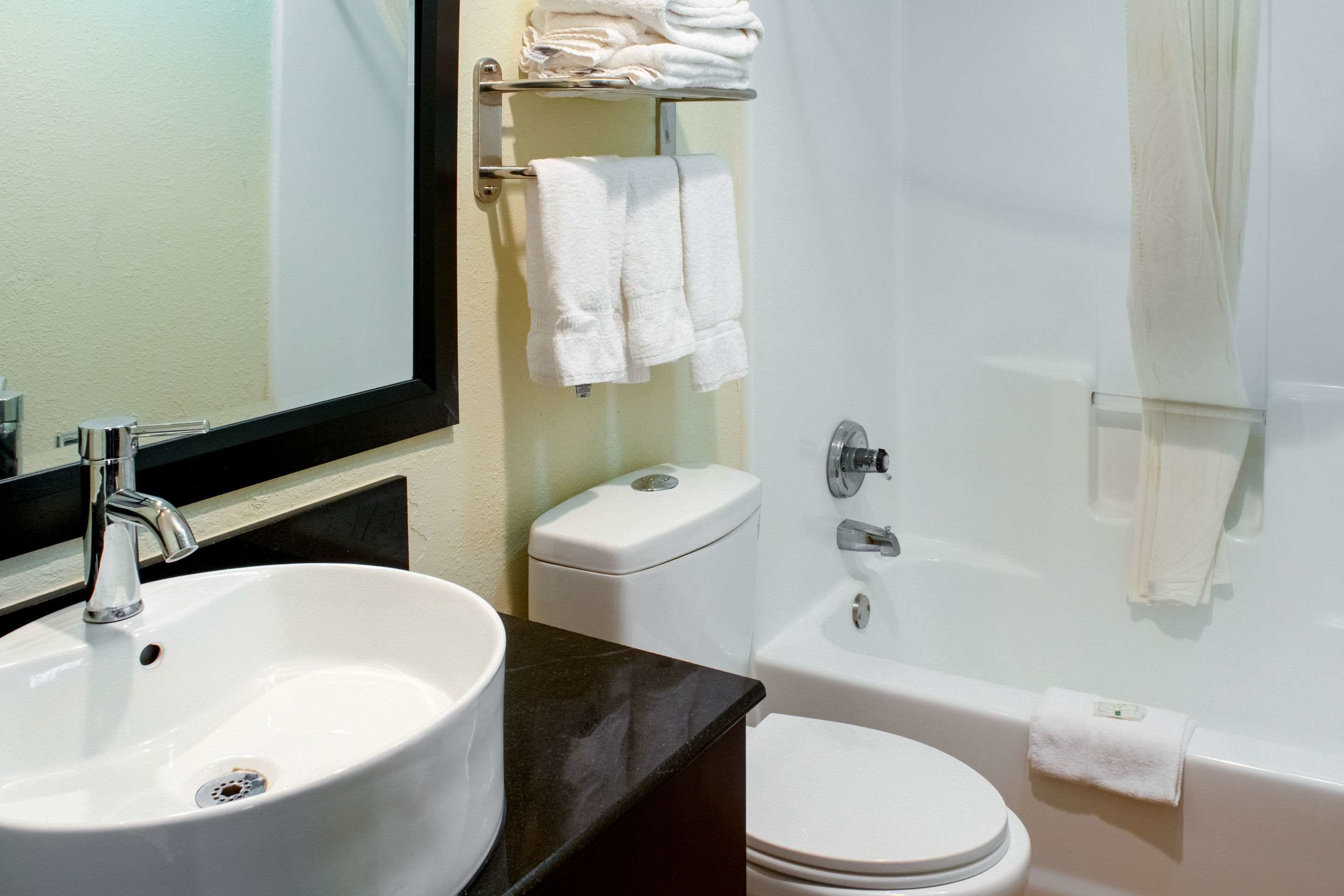 A bathroom with a sink, toilet, and bathtub.