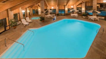 Relax by the pool surrounded by lounge chairs and tables.
