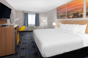 A hotel room with a bed, a desk with a chair, a flat-screen TV, a window with curtains, and a painting on the wall. - Days Inn by Wyndham Wooster (Wooster)