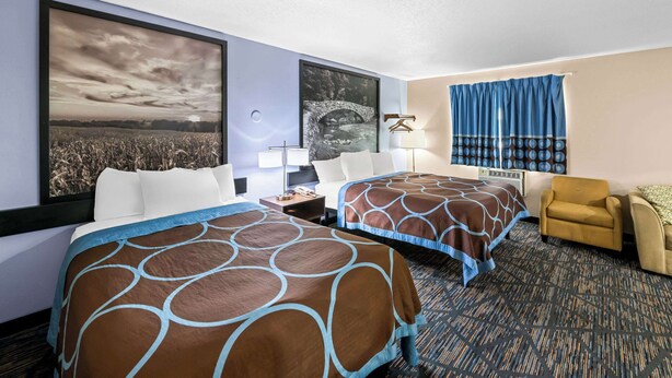 A hotel room with two beds, a desk, a chair, and a large window with curtains. - Super 8 by Wyndham Council Bluffs IA Omaha NE Area (Council Bluffs)