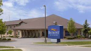 A Baymont Inn & Suites building with a brick facade, large windows, and a prominent sign. - Baymont by Wyndham Whitewater (Whitewater)