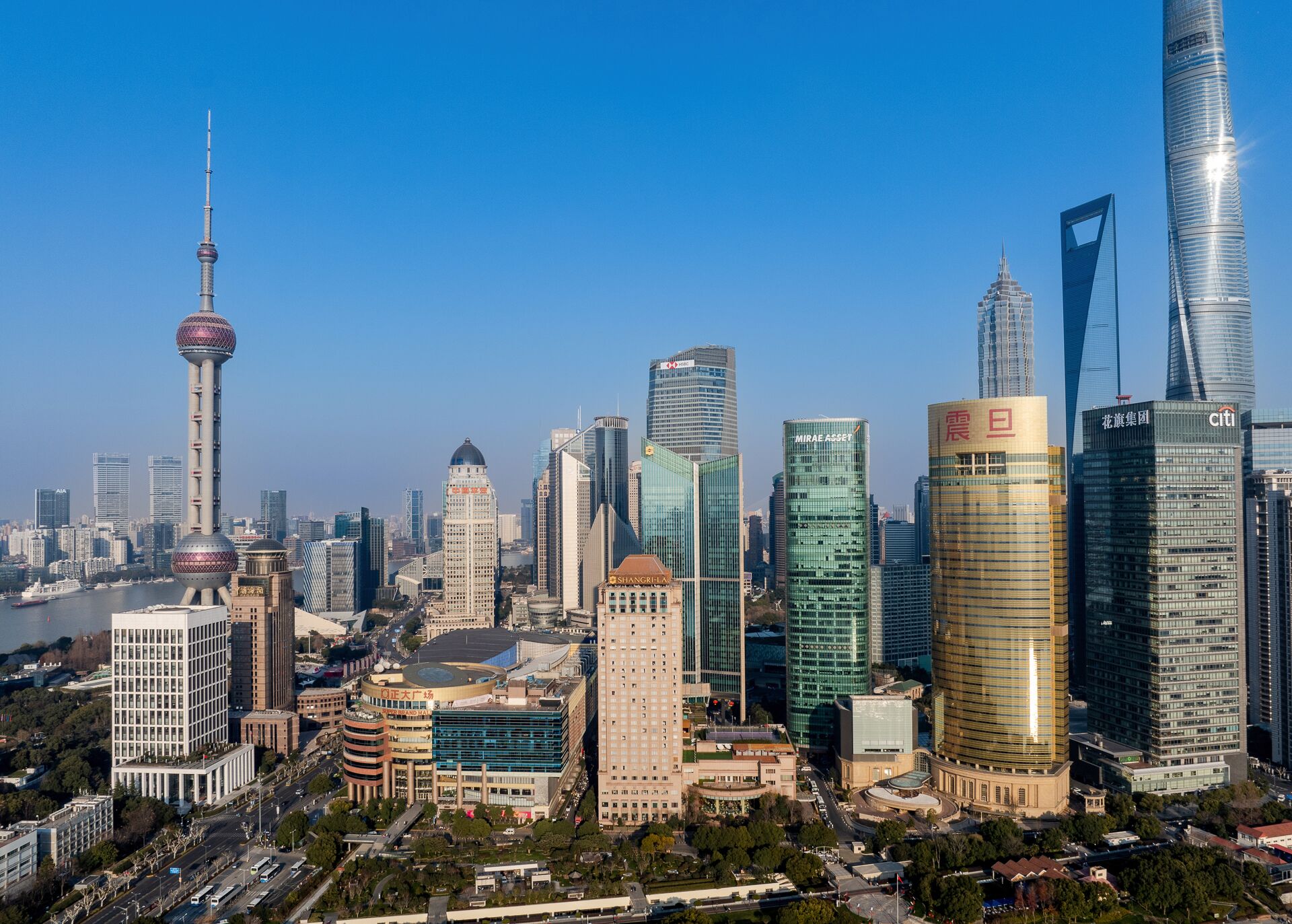 A cityscape with modern skyscrapers, including a distinctive tower with a spherical observation deck.