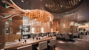 A modern restaurant with a unique ceiling sculpture, contemporary furniture, and a clean, minimalist design. - Pudong Shangri-La, Shanghai (Shanghai)