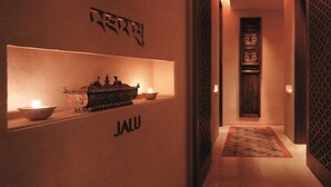 A hallway with a traditional Asian altar featuring a brass statue, a lit candle, and a bowl. The word "JALU" is displayed above the altar. - Pudong Shangri-La, Shanghai (Shanghai)