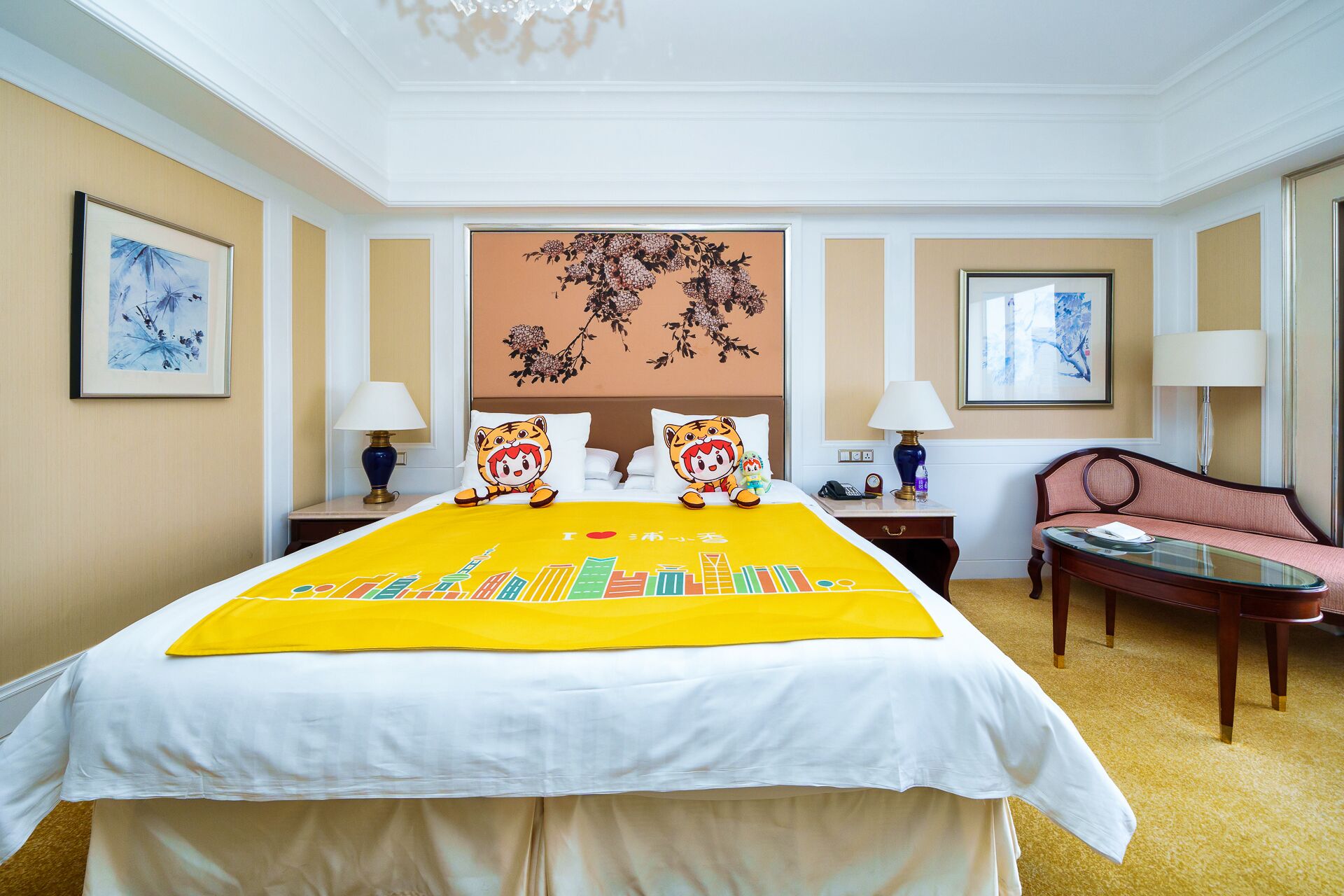 A hotel room with a large bed, two nightstands, a desk, and a chair.