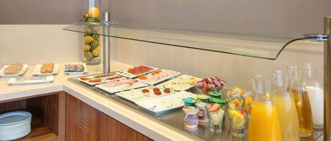 A buffet with various food items and beverages.