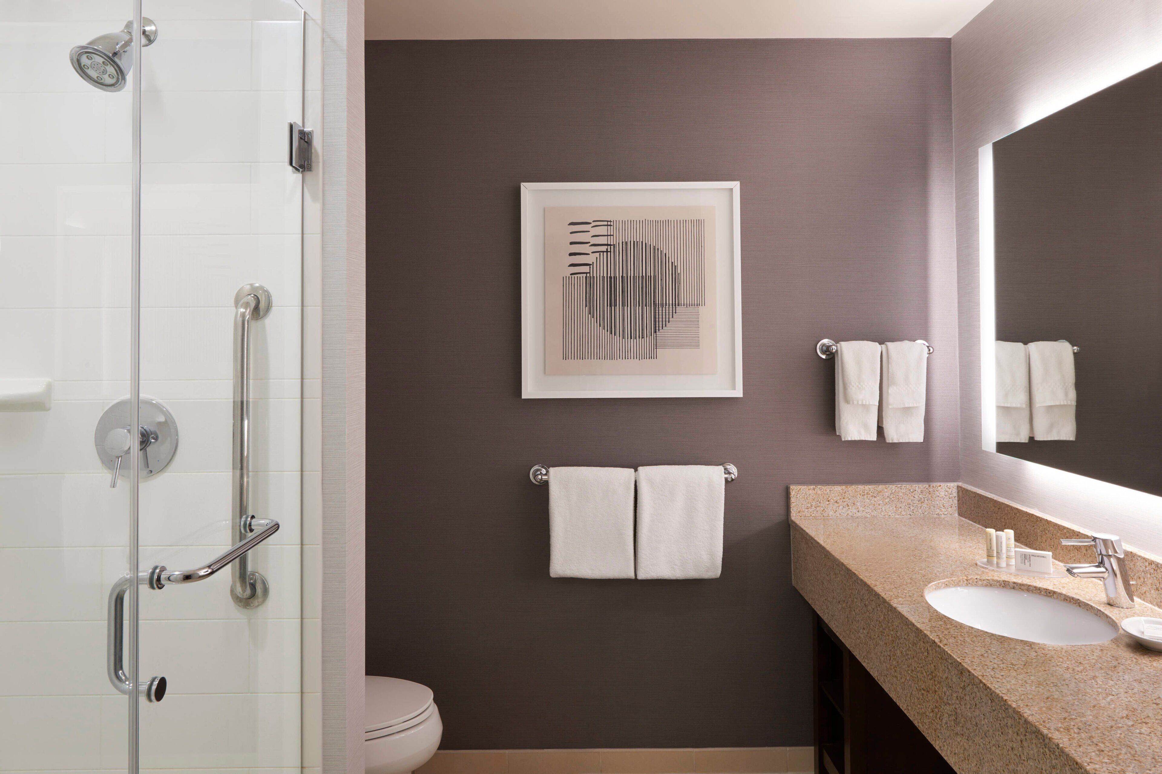 shower, designer toiletries, hair dryer, towels